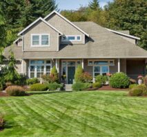 A home with a well-maintained lawn and trees in the front yard.