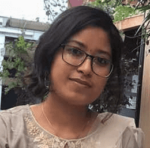 A young woman wearing glasses and a t-shirt. A Young Woman Wearing Glasses And A T Shirt.